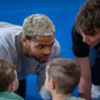 Student instructing activity with children